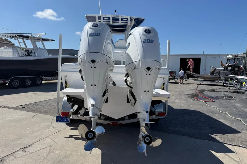 Slide: The Image of 2025 Bluewater 25t boat with dual Yamaha 200 engines at a marina. - 4