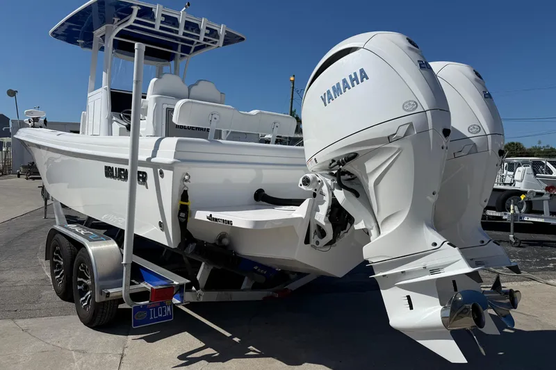Slide: The Image of 2025 Bluewater 25t boat with dual Yamaha engines on a trailer, parked outdoors. - 5