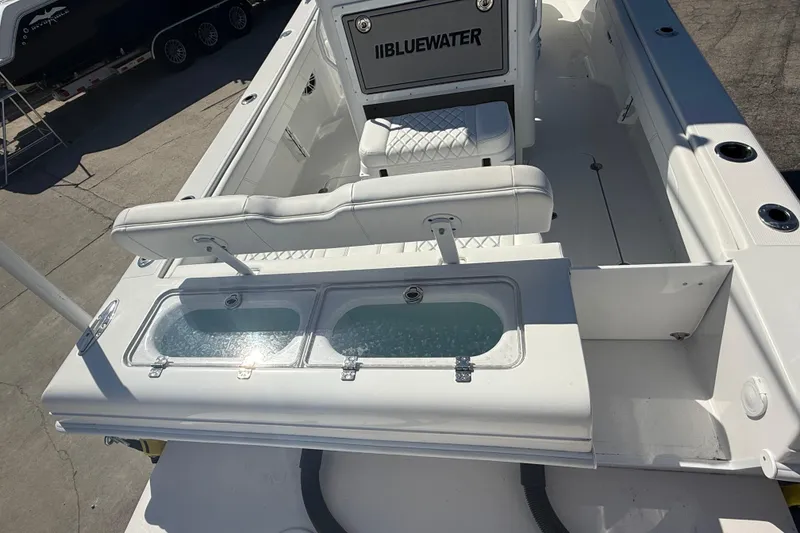 Slide: The Image of 2025 Bluewater 25t boat interior with seating and dual live wells. - 7