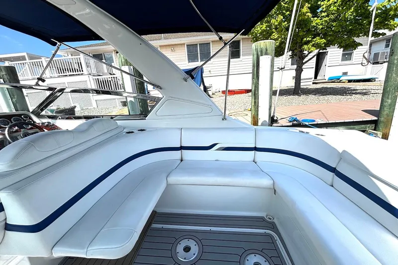 Slide: The Image of 2004 Formula 330 Sun Sport boat interior with white seating and blue accents. - 10