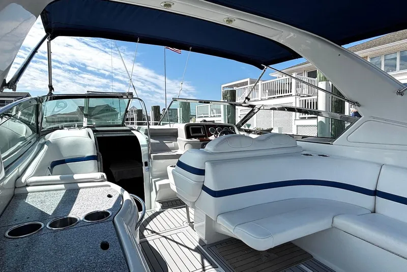 Slide: The Image of 2004 Formula 330 Sun Sport boat interior with white seating and blue accents. - 12