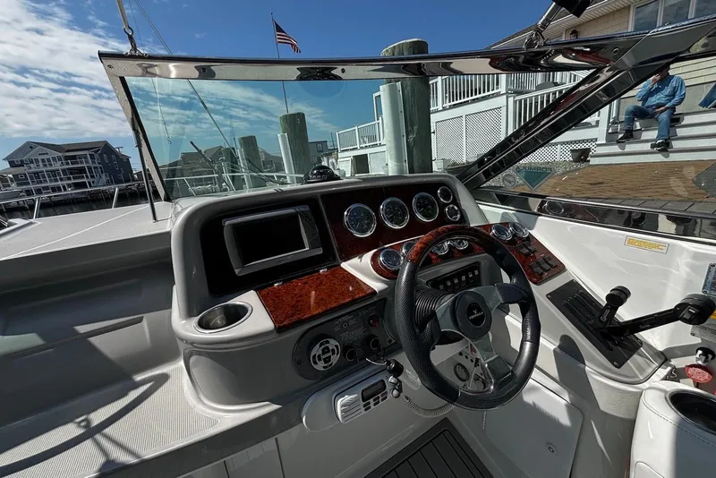 Slide: The Image of Cockpit of 2004 Formula 330 Sun Sport boat with steering wheel and dashboard controls. - 16