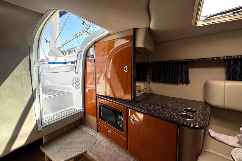 Slide: The Image of Interior of a 2004 Formula 330 Sun Sport boat with kitchenette and seating area. - 17