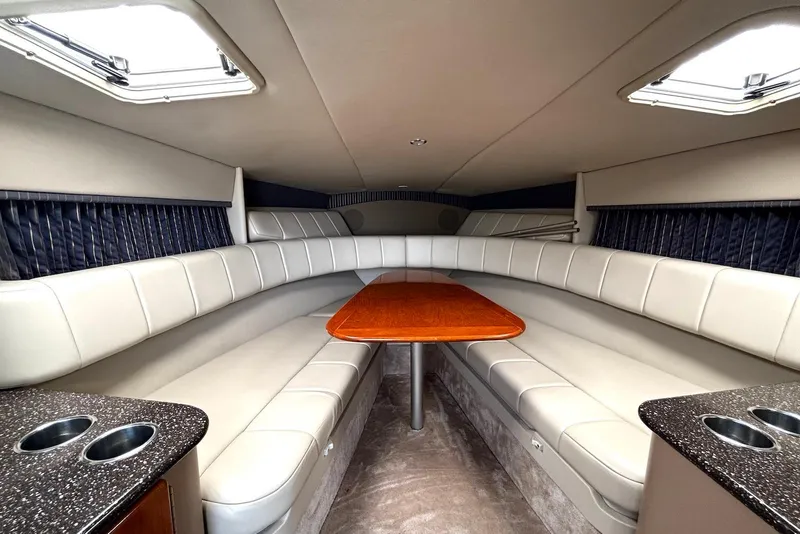 Slide: The Image of Interior of 2004 Formula 330 Sun Sport boat with plush seating and wooden table. - 18