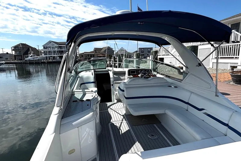 Slide: The Image of 2004 Formula 330 Sun Sport boat docked, featuring spacious seating and sleek design. - 9