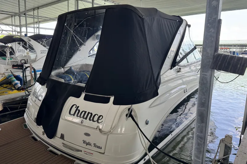 Slide: The Image of 2006 Chaparral 330 Signature boat docked with black cover, named "Chance." - 10
