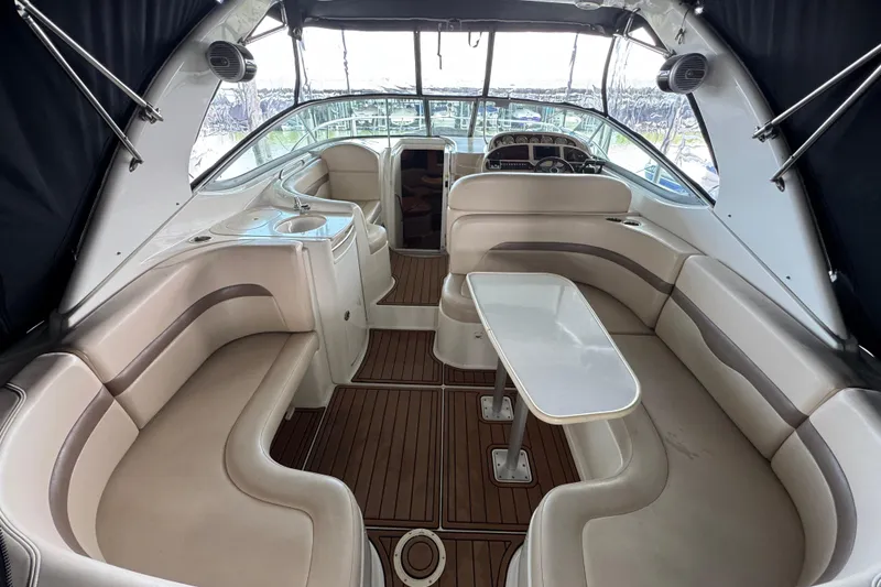Slide: The Image of 2006 Chaparral 330 Signature boat interior with plush seating and wooden flooring. - 14