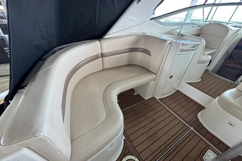 Slide: The Image of 2006 Chaparral 330 Signature boat interior with beige seating and wood flooring. - 16