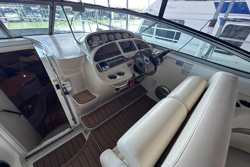 Slide: The Image of 2006 Chaparral 330 Signature boat interior with helm, steering wheel, and seating. - 19