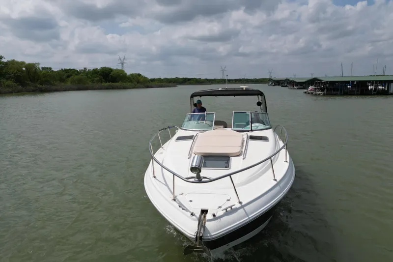 Slide: The Image of 2006 Chaparral 330 Signature boat cruising on a calm river under cloudy skies. - 2