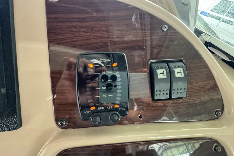 Slide: The Image of Control panel of a 2006 Chaparral 330 Signature boat with trim tab indicators. - 23