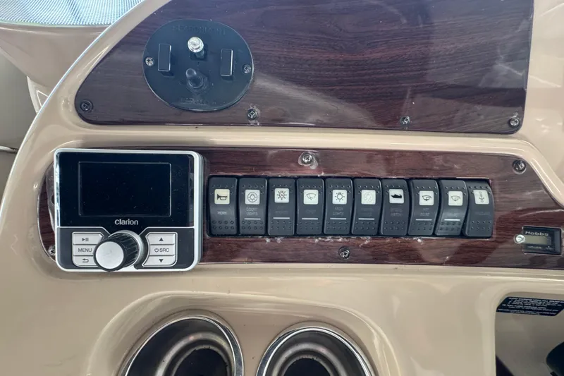 Slide: The Image of Control panel of a 2006 Chaparral 330 Signature boat with switches and Clarion audio system. - 25