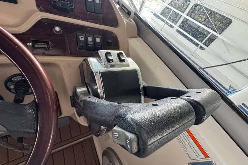 Slide: The Image of 2006 Chaparral 330 Signature boat helm with controls and steering wheel. - 26