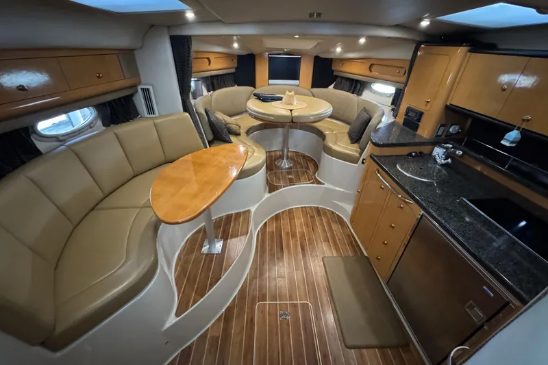 Slide: The Image of Luxurious interior of 2006 Chaparral 330 Signature yacht with elegant seating and kitchenette. - 27