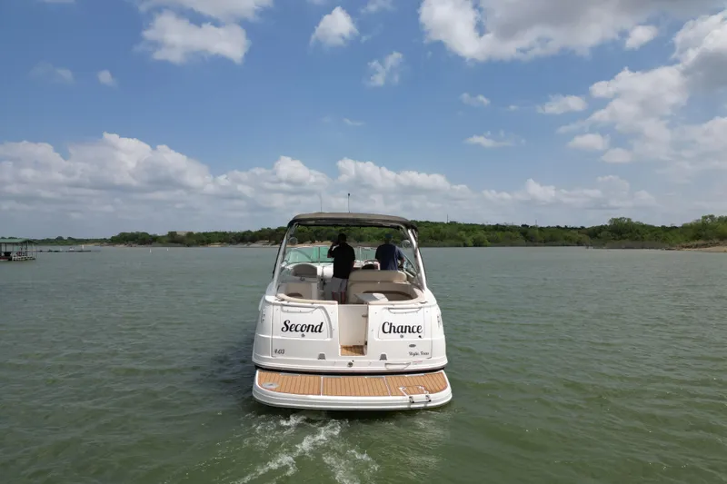 Slide: The Image of 2006 Chaparral 330 Signature boat cruising on a lake under a partly cloudy sky. - 3
