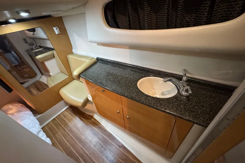 Slide: The Image of Luxurious bathroom interior of 2006 Chaparral 330 Signature yacht with wood accents and modern fixtures. - 31