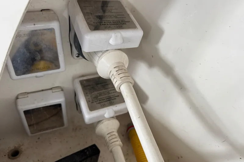 Slide: The Image of Electrical connections on a 2006 Chaparral 330 Signature boat, featuring power cables and outlets. - 38