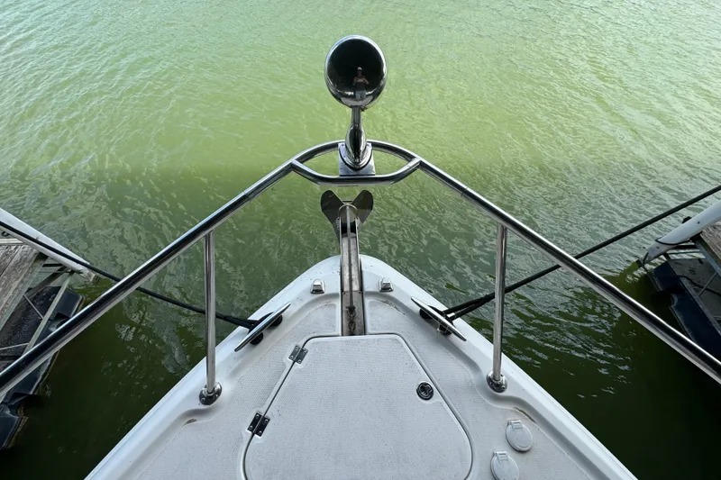 Slide: The Image of Bow view of 2006 Chaparral 330 Signature boat on green water. - 40