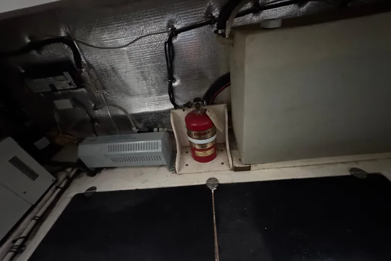 Slide: The Image of Engine room of 2006 Chaparral 330 Signature with fire extinguisher and equipment. - 48