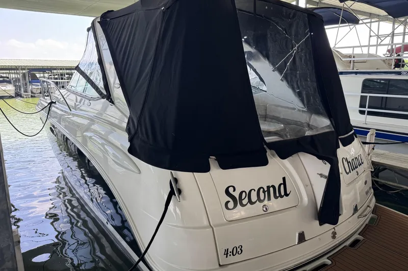 Slide: The Image of 2006 Chaparral 330 Signature boat docked, featuring black canopy and "Second Chance" name. - 5