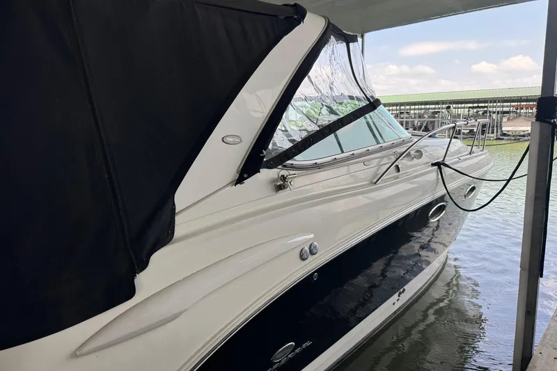 Slide: The Image of 2006 Chaparral 330 Signature boat docked, featuring sleek design and black canopy. - 9