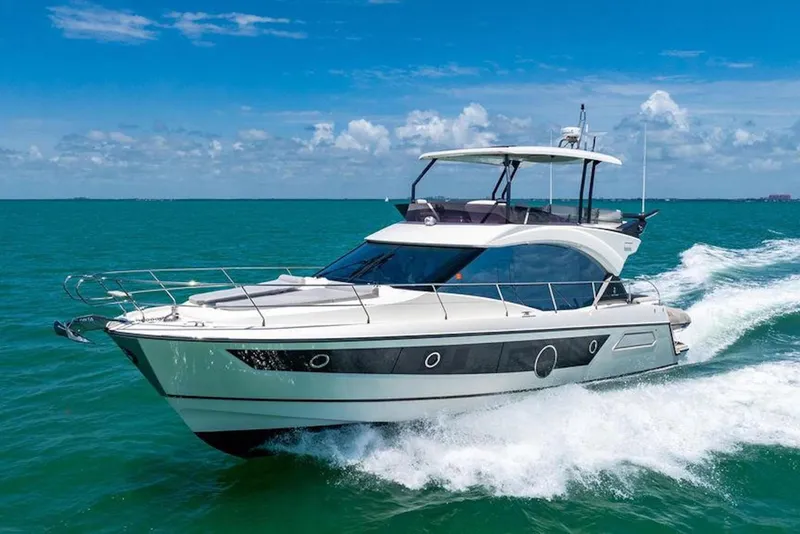 The Image of 2020 Beneteau Monte Carlo 52 yacht cruising on turquoise waters under a clear blue sky. - 0