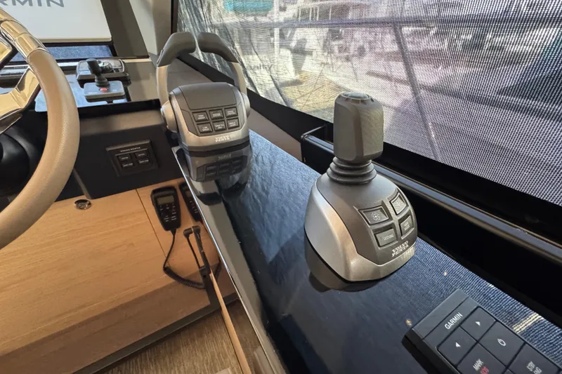 Slide: The Image of Control panel of 2020 Beneteau Monte Carlo 52 yacht with joystick and steering wheel. - 22