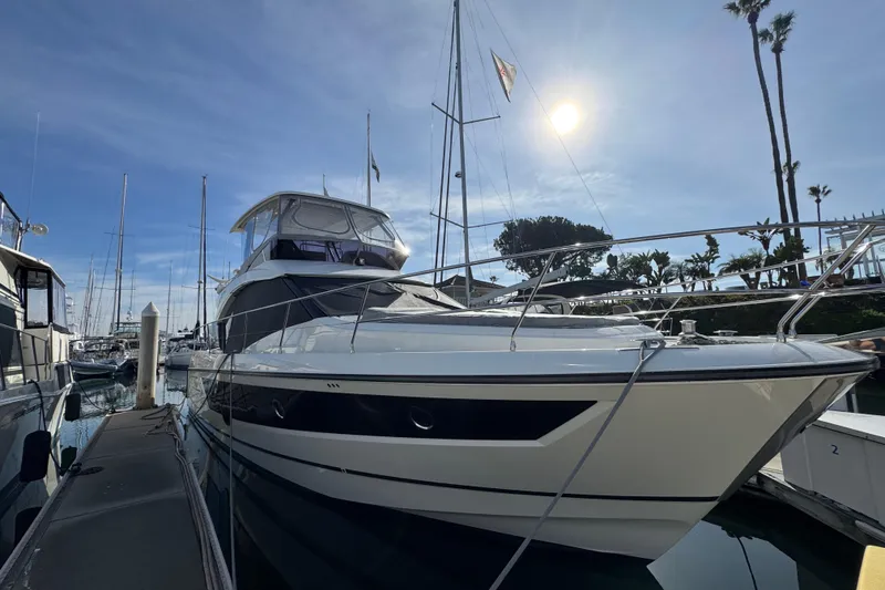 Slide: The Image of 2020 Beneteau Monte Carlo 52 yacht docked in sunny marina. - 3