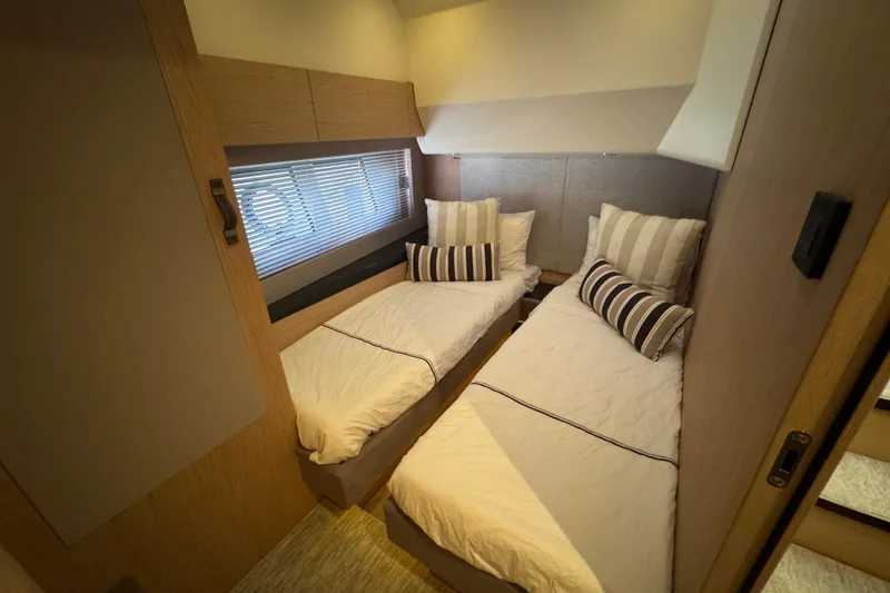 Slide: The Image of Twin cabin interior of 2020 Beneteau Monte Carlo 52 yacht with striped pillows. - 37