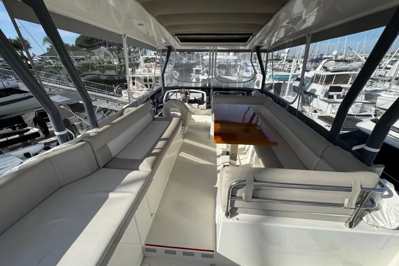 Slide: The Image of Luxurious interior of 2020 Beneteau Monte Carlo 52 yacht with spacious seating and table. - 42