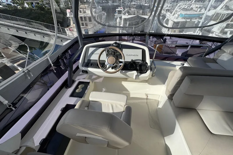 Slide: The Image of 2020 Beneteau Monte Carlo 52 helm with Garmin navigation, luxurious seating, and panoramic views. - 45