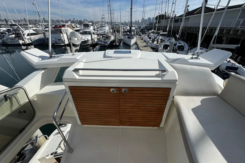 Slide: The Image of 2020 Beneteau Monte Carlo 52 yacht deck with wooden cabinet, docked at marina. - 50