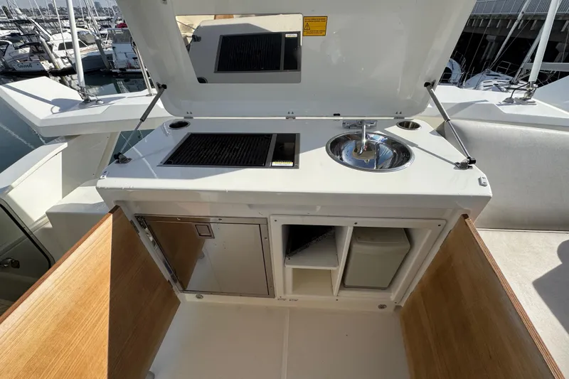 Slide: The Image of Outdoor kitchenette on 2020 Beneteau Monte Carlo 52 yacht with grill and sink. - 52