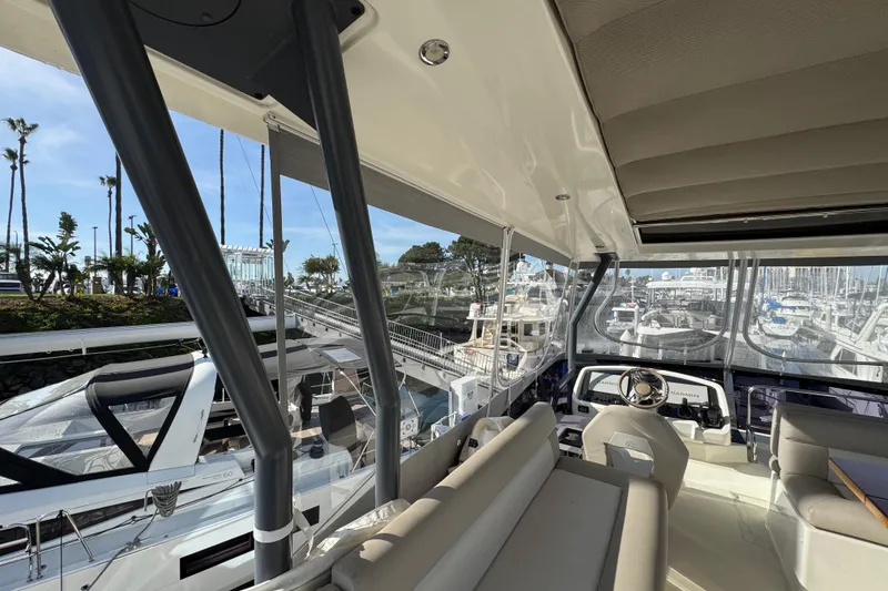 Slide: The Image of Interior view of 2020 Beneteau Monte Carlo 52 yacht at marina, showcasing helm and seating area. - 54