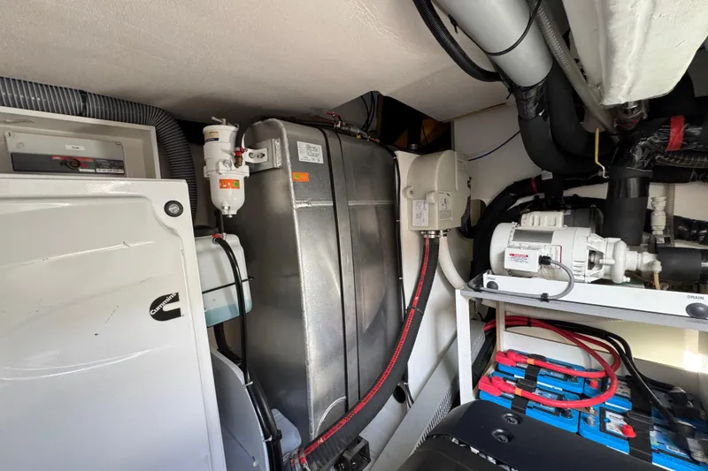 Slide: The Image of Engine room of 2020 Beneteau Monte Carlo 52 yacht, featuring mechanical components and wiring. - 59