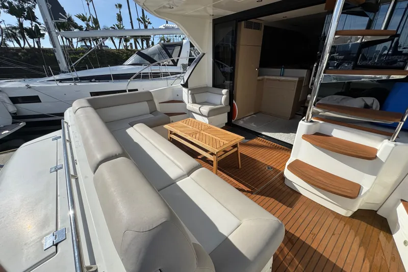 Slide: The Image of Luxurious 2020 Beneteau Monte Carlo 52 yacht interior with elegant seating and wooden accents. - 7