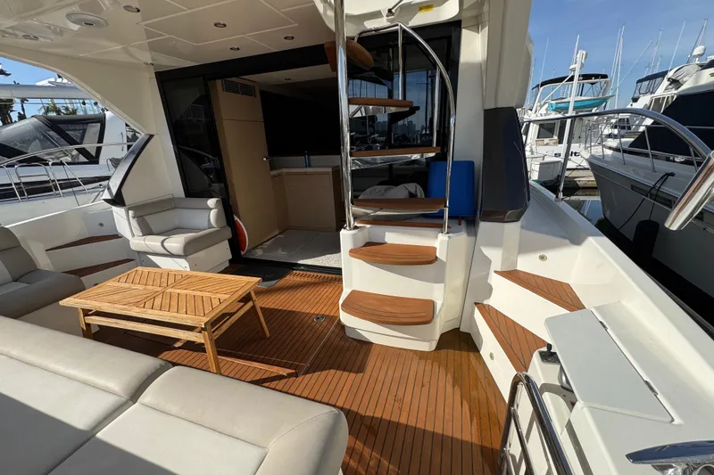 Slide: The Image of Luxurious 2020 Beneteau Monte Carlo 52 yacht interior with wooden deck and elegant seating. - 8