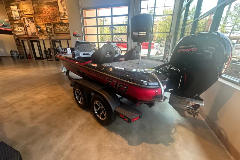 Slide: The Image of 2025 Nitro Z18 Pro bass boat with Mercury Pro XS engine in showroom. - 2
