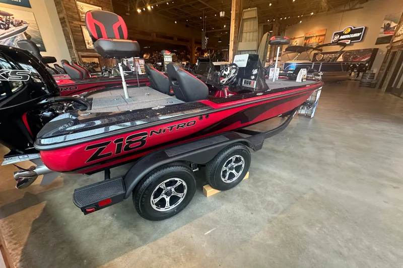 Slide: The Image of 2025 Nitro Z18 Pro boat displayed indoors, featuring sleek red and black design. - 1