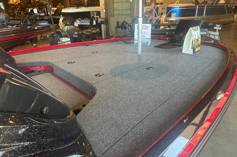 Slide: The Image of 2025 Nitro Z18 Pro boat deck with carpeted surface and fishing equipment. - 11