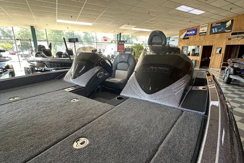 Slide: The Image of 2024 Triton 18 TrX boat interior in showroom, featuring sleek design and spacious seating. - 54