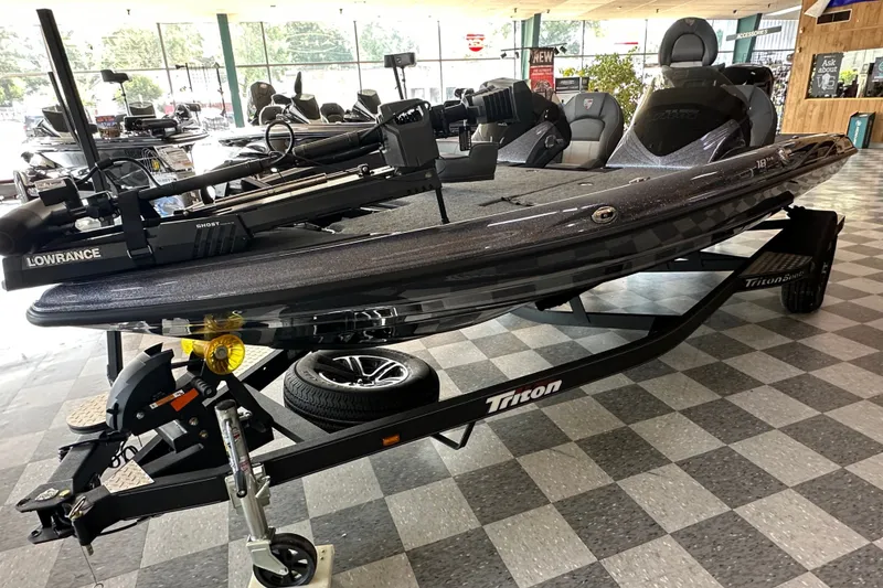 Slide: The Image of 2024 Triton 18 TrX bass boat on display with Lowrance equipment. - 3