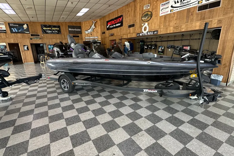 Slide: The Image of 2024 Triton 18 TrX bass boat displayed in a showroom with checkered flooring. - 1