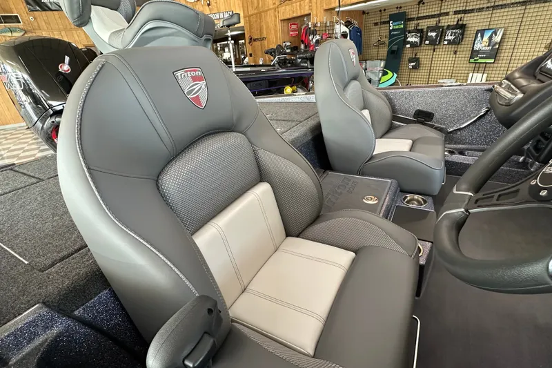 Slide: The Image of 2024 Triton 18 TrX boat interior with gray and white cushioned seats. - 12