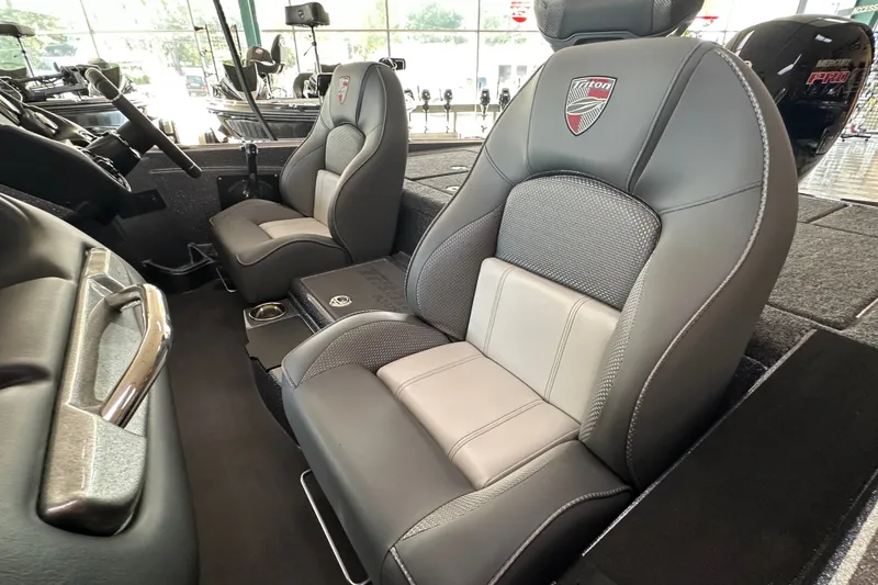 Slide: The Image of 2024 Triton 18 TrX boat interior with sleek, modern seating and steering wheel. - 52