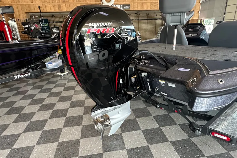 Slide: The Image of 2024 Triton 18 TrX boat with Mercury Pro XS 150 engine in showroom. - 6