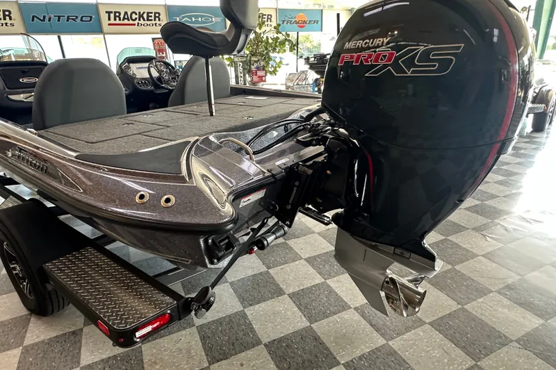 Slide: The Image of 2024 Triton 18 TrX boat with Mercury Pro XS engine in showroom. - 5