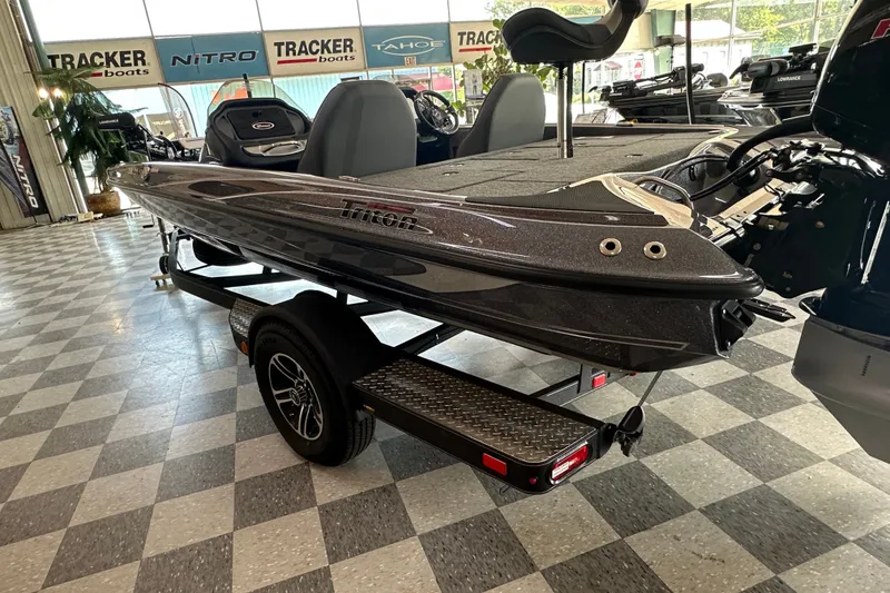 Slide: The Image of 2024 Triton 18 TrX boat on display in showroom with checkered floor. - 4