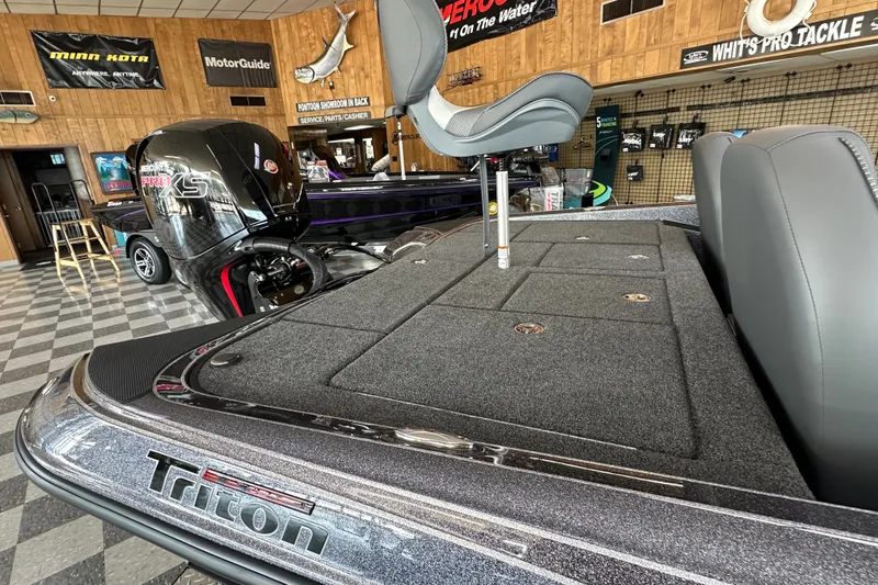 Slide: The Image of 2024 Triton 18 TrX boat interior with Mercury Pro XS engine in showroom. - 51