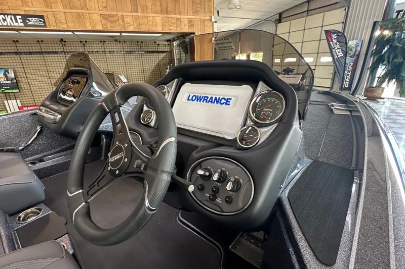 Slide: The Image of 2024 Triton 18 TrX boat dashboard with Lowrance display and steering wheel. - 11